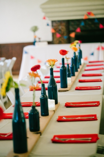 Painted bottles, wooden boards, and bunting at the reception 
