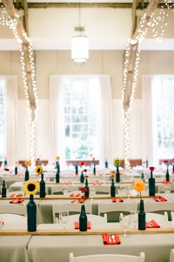Painted bottles, wooden boards, and twinkly lights at the reception